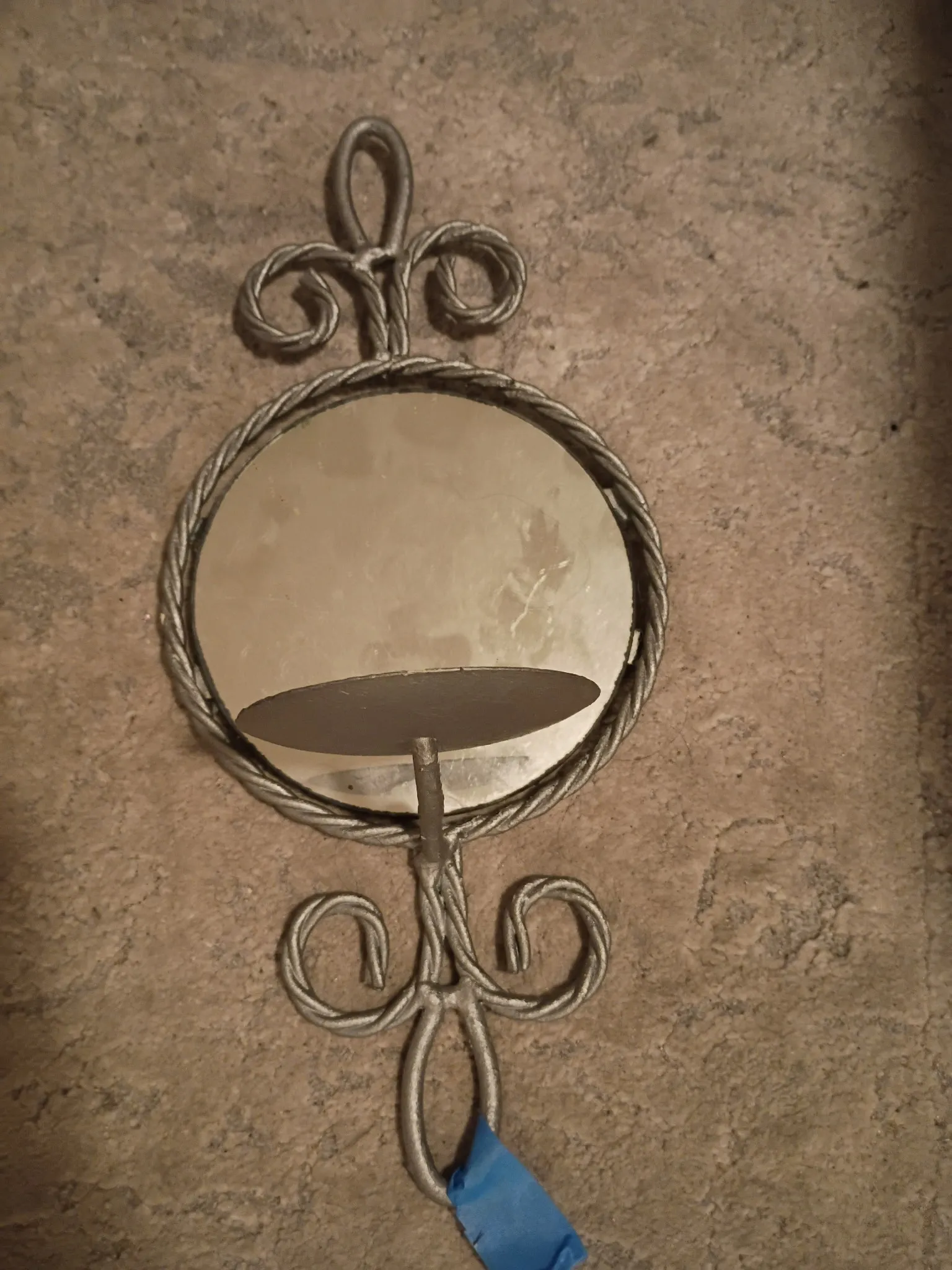 Wall sconce before refinishing: worn silver-tone metal with round mirror