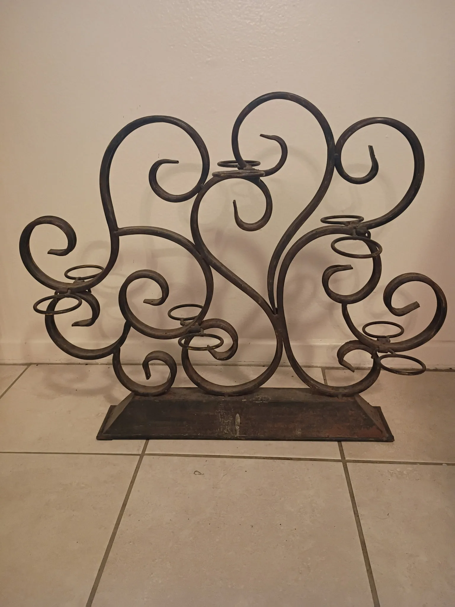 Scrollwork candelabra before refinishing: dusty tarnished iron